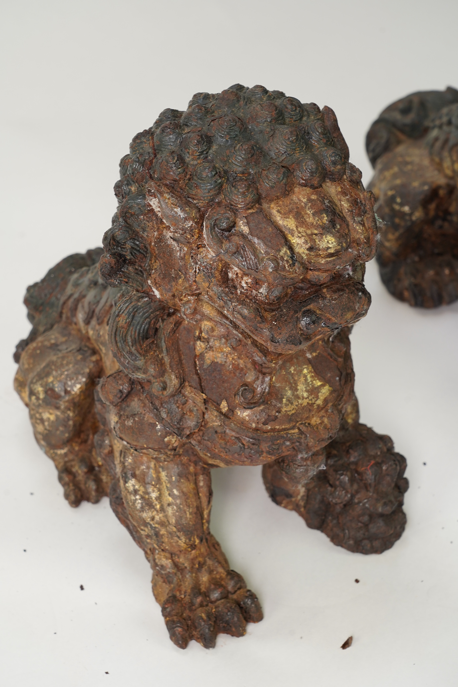 A pair of large Chinese polychrome lacquered cast iron models of lion temple guardians, Qing dynasty